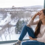 teenager sitting in window suffering from anxiety