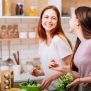 women smiling while making nutritious food